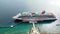 Cruise ship sailing through the caribbean ocean taking all the summer tourists on holiday on the island drone footage