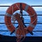 A cruise ship sign life ring hanging on the railing to be used in case of emergency