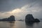 Cruise ship at sunset between karst rock foramtions in Ha Long Bay Vietnam