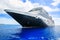 Cruise ship and tender on a light blue sea at Half Moon Cay in t