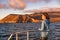 Cruise ship tourist on boat looking at sunset landscape in Galapagos Islands