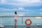 Cruise ship travel tourist woman on boat deck looking a peaceful summer night sky after rain. Serene still ocean water