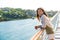 Cruise ship vacation Asian woman relaxing on deck enjoying view from boat of port of call city on St. Lucia island in the