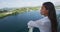 Cruise ship vacation Asian woman relaxing on deck enjoying view from boat of port of call city on St. Lucia island in