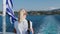 Cruise ship vacation in Greece. Young woman leaving greek island on cruise boat at sea. Romantic travel at sea looking