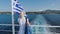 Cruise ship vacation in Greece. Young woman leaving greek island on cruise boat at sea. Romantic travel at sea looking