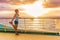 Cruise ship vacation healthy active running lifestyle. Fitness runner woman stretching leg warm-up before exercise on