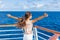 Cruise ship vacation woman enjoying travel vacation having fun at sea. Free carefree happy girl looking at ocean with open arms in