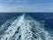 Cruise ship wake on a beautiful sunny day with white clouds and blue seas on the Atlantic Ocean