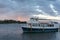 Cruise ship, water transport landscape with sunset sky and rainbow