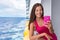 Cruise ship woman using mobile phone on travel vacation at ocean. Asian girl texting sms on boat wifi cellular data cellphone