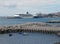 Cruise ships moored in the harbour in funchal portugal with smaller fishing boats in front of the concrete jetties