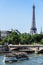 Cruise tourist ship with the Invalides Bridge and the Eiffel Tow