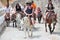 Cruise Tourists invading Santorini island riding traditional donkeys with colorful saddle