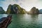 Cruise is a traditional wooden junk Halong bay islands sea landscape. Rock islands South China Sea Vietnam. Site Asia