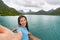 Cruise travel luxury vacation in Bora Bora Asian woman tourist taking selfie picture with phone on deck of cruising ship