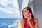 Cruise travel woman talking on the phone calling someone on travel vacation at ocean. Asian girl holidays. Internet international