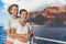 Cruise vacation couple tourists in love whale watching at sunset on ship deck outside. Happy travel vacation lifestyle