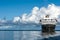 Cruiser, Cruise Liner on River Amazon with huge white Cumulonimbus Clouds