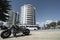 Cruiser motorbike parked on berm at Mount MAin Beach with Oceanscide twin Towers background