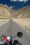 Cruising on a motorcycle on the road to Nubra valley among the picturesque Himalaya mountains in Ladakh region, India.