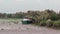 Cruising past an anchored small boat in the Mekong Delta