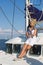 Cruising: Sailing woman on a luxury sail boat in summer.