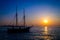 Cruising ship, sailing at sunset