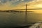 Cruising up the river Tagus towards the 25th of April bridge in Lisbon, Portugal in the golden early morning light