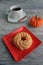 Cruller dough nut with mug of pumpkin spice coffee