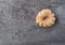 Cruller shaped donut on a gray background