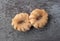 Cruller shaped donuts on a gray background