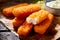 Crumbed fish fingers in sticks with tartare sauce