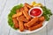 Crumbed fish sticks served with ketchup