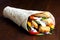 Crumbed fried chicken and salad tortilla wrap with white sauce i