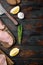 Crumbed uncooked chicken breast ingredient on dark wooden background, flat lay with space for text