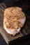 Crumbed uncooked chicken breast ingredient on wooden table