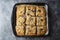 Crumble fruit pie. Homemade sweet pie slices in baking pan. Top view