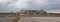 Crumbled concrete building with piles of debris. panoramic photo shot