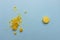 Crumbled yellow macaroon cookie vs unbroken macaroon on blue flat background