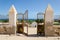 Crumbling metal gate of colonial stone wall overlooking beautiful ocean in Angola