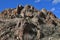 A crumbling rock formation with a bright blue sky