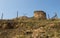 Crumblinng Stone Ruin on Hill Behind Electric Fence