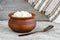 Crumbly homemade cottage cheese  in a clay pot