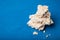 Crumbs and wreckage of dietary rice crispy snacks on a blue background, empty space for text