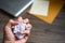 Crumpled balls of white paper in hand over wooden table, workspace