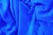 Crumpled blue fabric. Empty textile background, top view