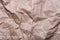 Crumpled cream craft paper background texture