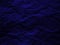 Crumpled dark blue paper texture background