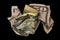 Crumpled fifty dollar bill on black background